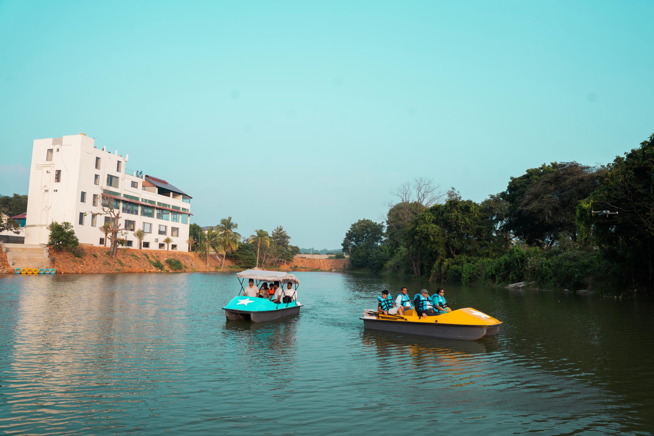 Family enjoying boating and rain dance activities at Lake Valley Resort in Tirupati.